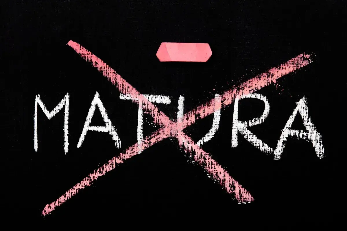 Napis "MATURA" przekreślony różową kredą, jakby na poprawki matur. Obok leży gumka.