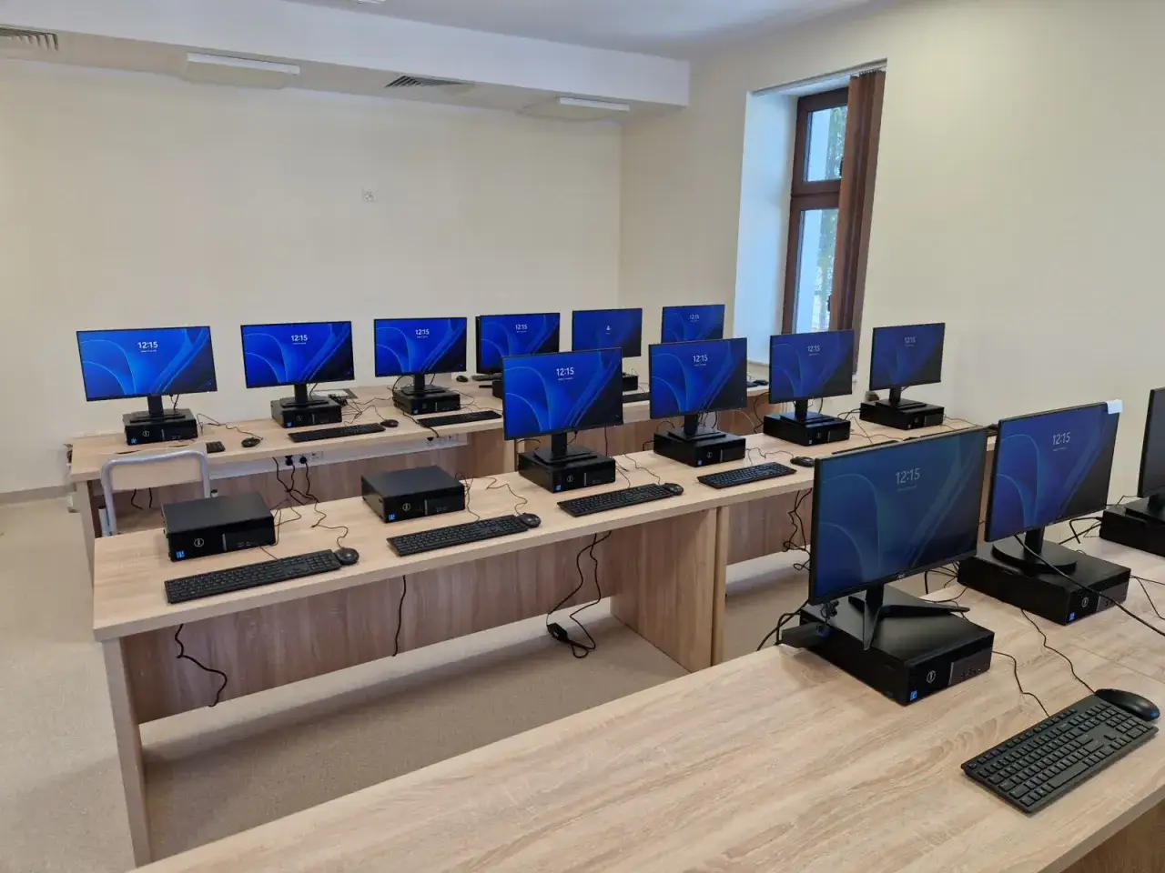 Sala komputerowa z rzędami stanowisk, gotowa na przyszłego technika informatyka.